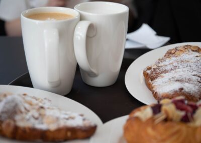 Delicious coffee and croissants served on a cozy cafe table, perfect for breakfast indulgence.